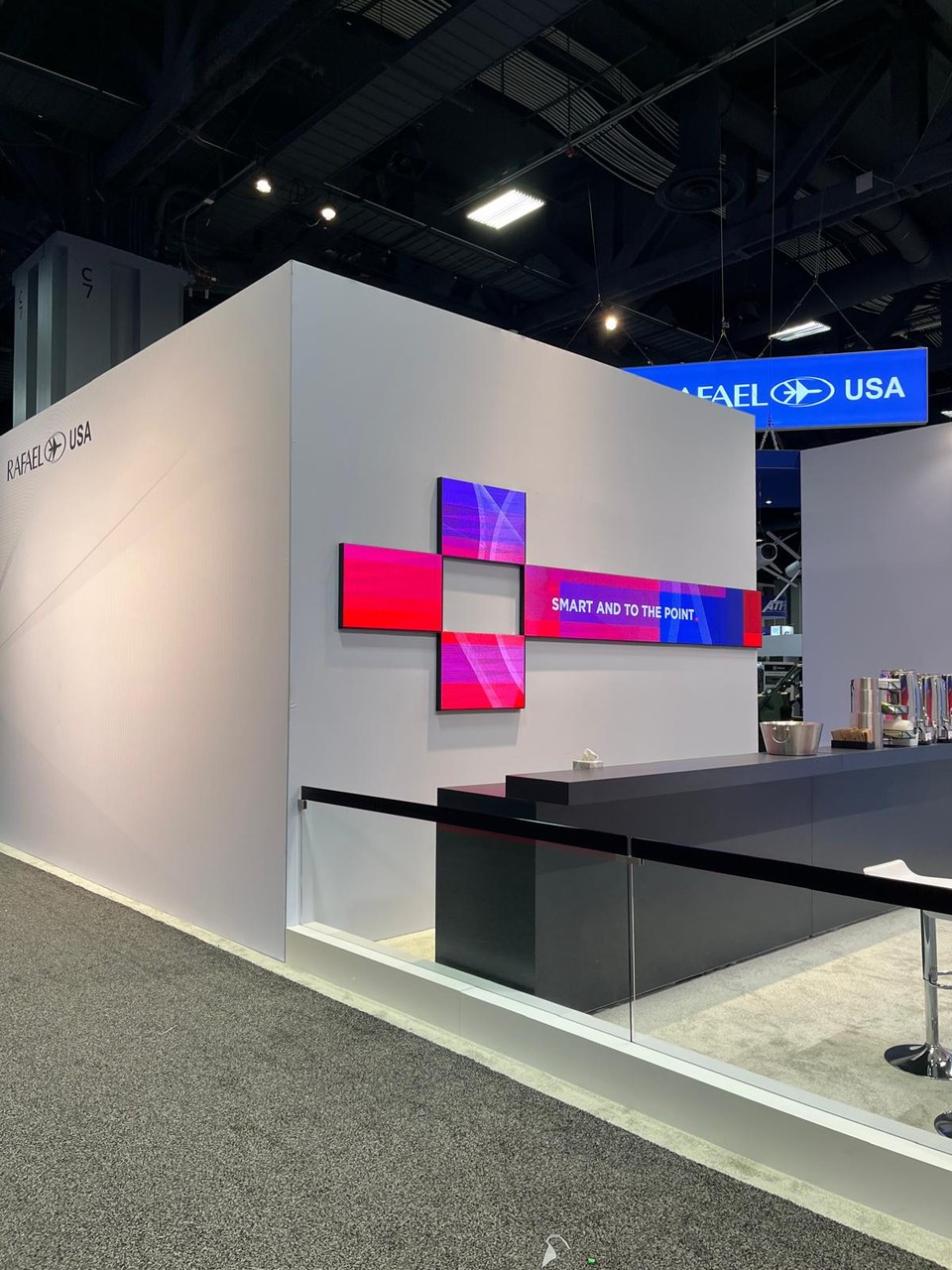 Rafael USA wall with cross-shaped screens reading Smart and to the Point.