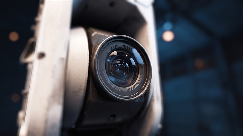 A close view of a camera lens in a technical housing.