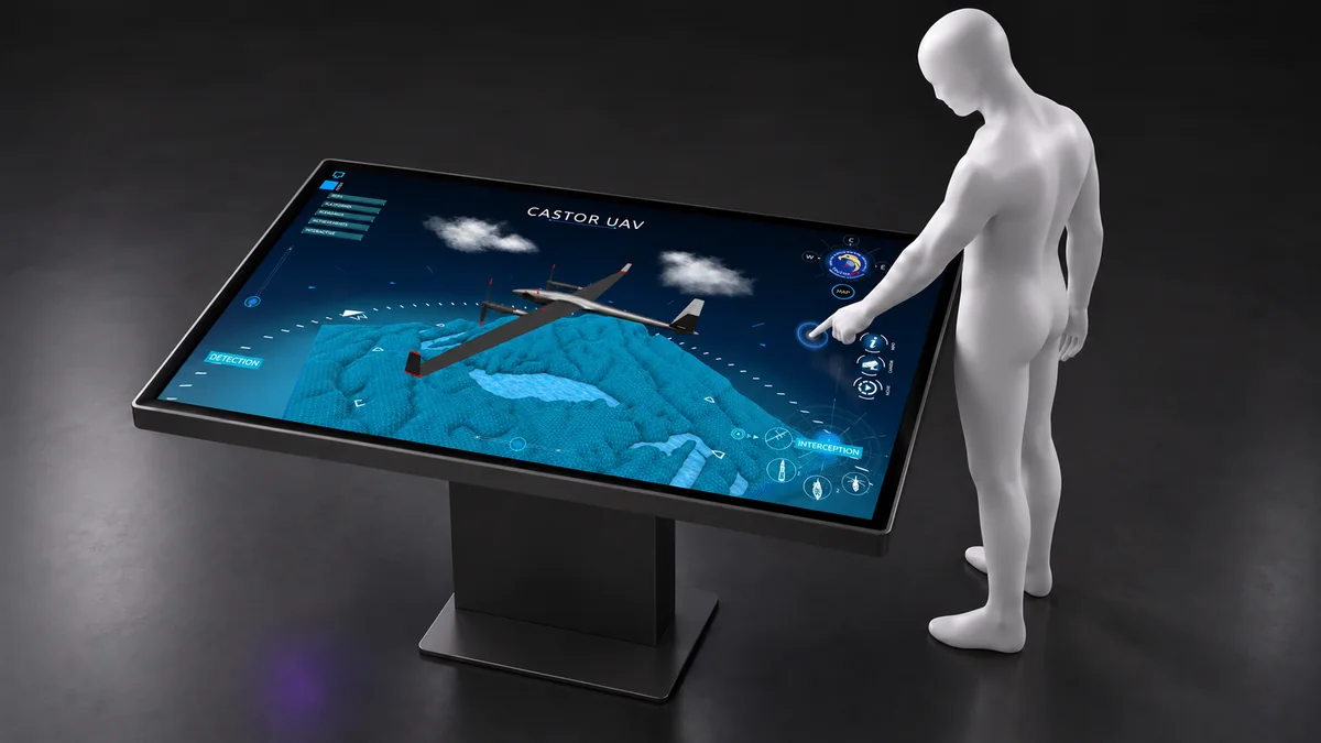 A visitor touches a single presentation screen displaying a CASTOR UAV.